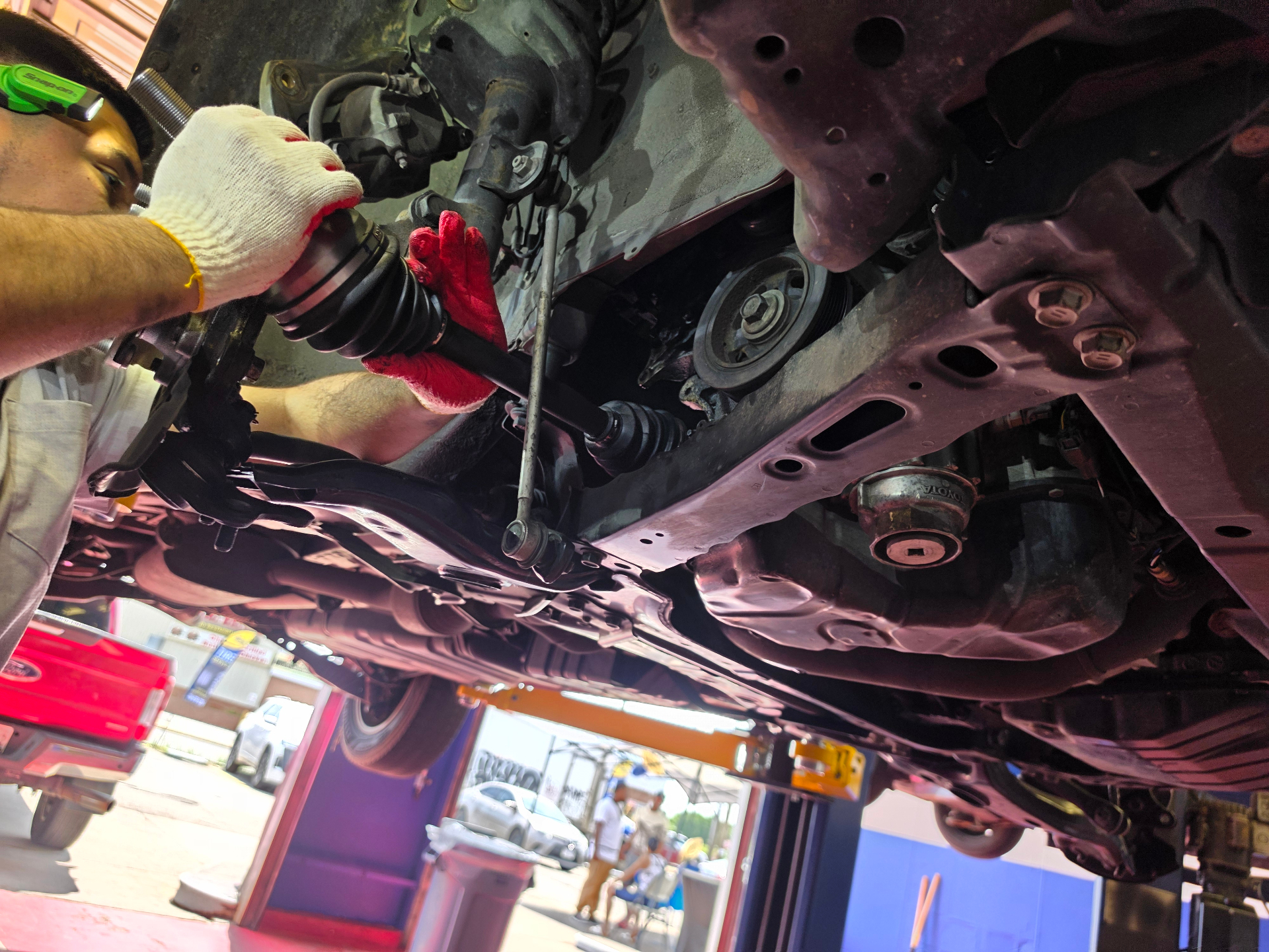 Diaz Auto Clinic technician working under a vehicle on Annapolis Rd in Bladensburg, Maryland